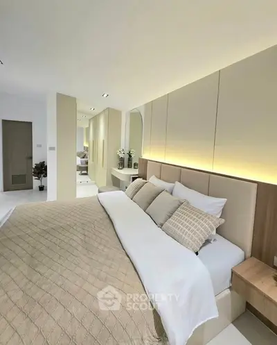 Luxurious modern bedroom with elegant lighting and plush bedding