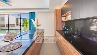 Modern kitchen with sleek design and pool view, featuring open layout and stylish cabinetry.