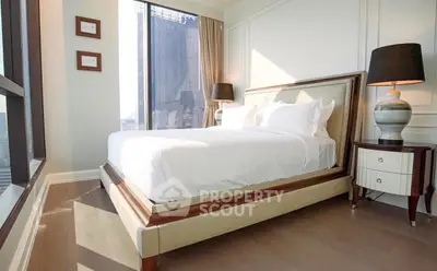 Luxurious bedroom with elegant decor and city view, featuring a stylish bed and modern lamps.
