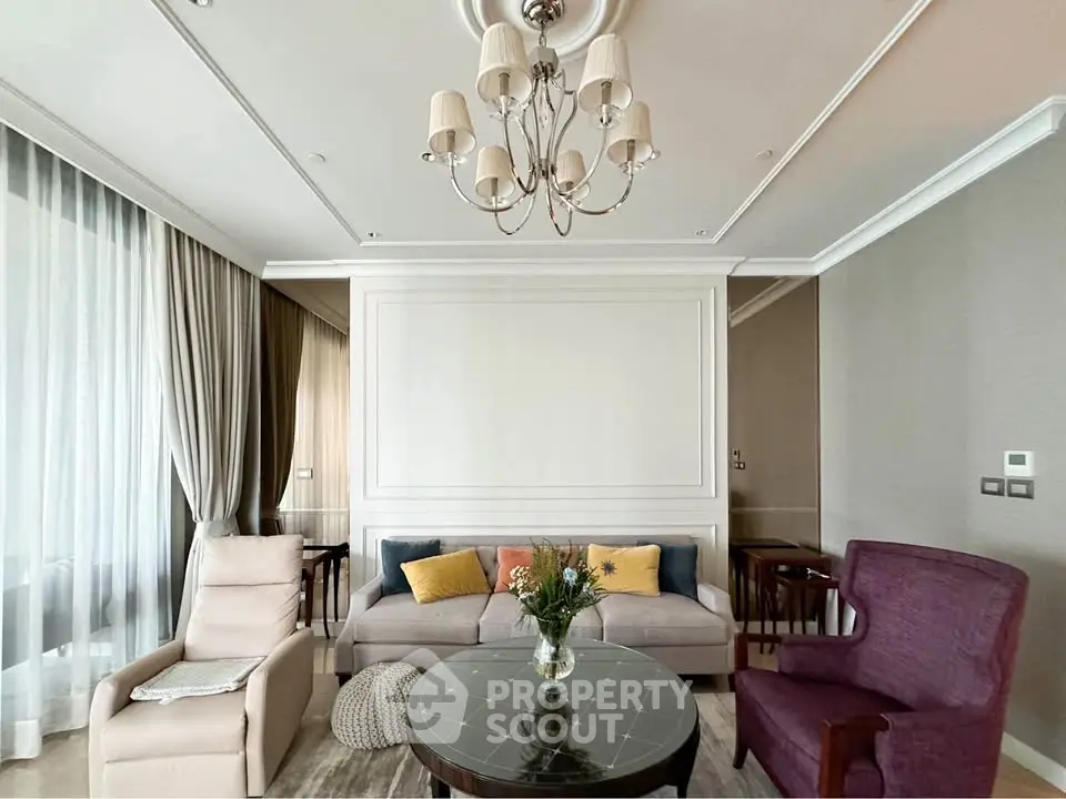 Elegant living room with plush seating and chandelier in modern apartment