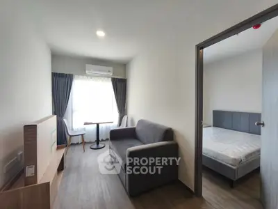 Modern apartment interior with cozy living room and bedroom, featuring stylish furniture and natural light.