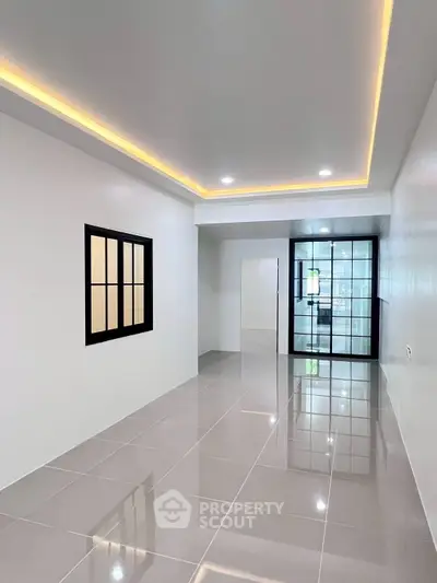 Modern minimalist interior with sleek tile flooring and recessed lighting