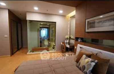 Modern bedroom with ensuite bathroom and stylish decor in a contemporary apartment.