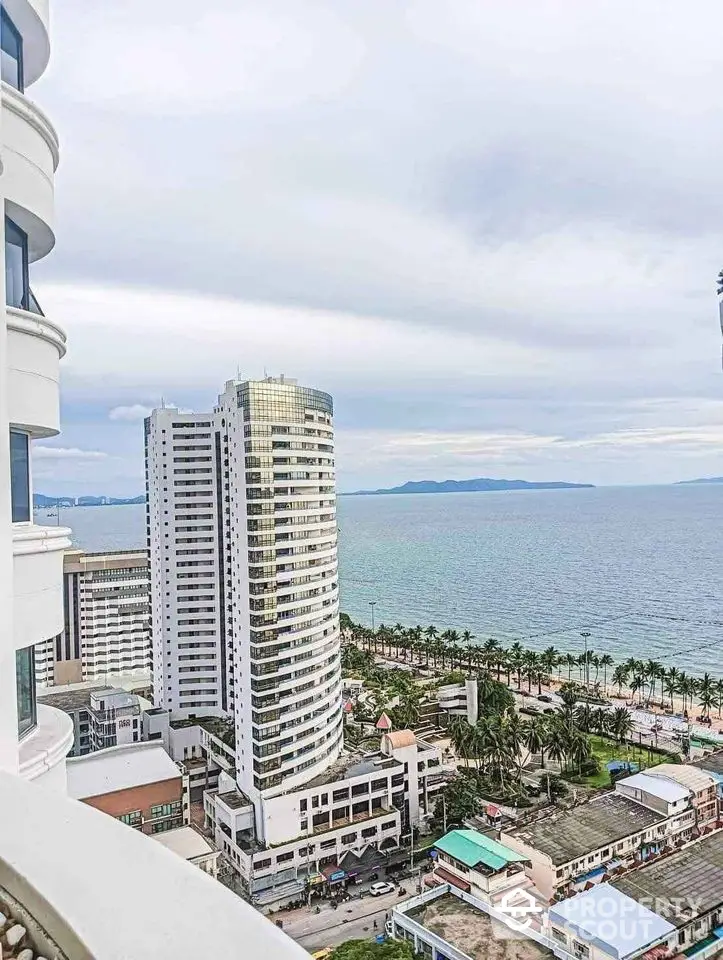 Stunning ocean view from high-rise balcony overlooking cityscape and coastline