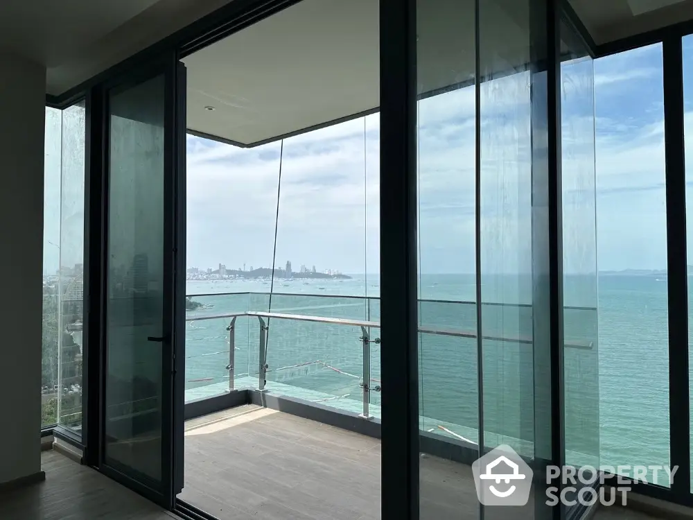 Stunning ocean view from modern glass balcony in high-rise apartment