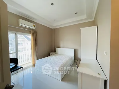Bright and airy bedroom with modern furnishings and balcony view.