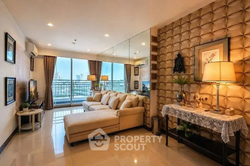 Luxurious living room with elegant decor and stunning city view from large balcony.