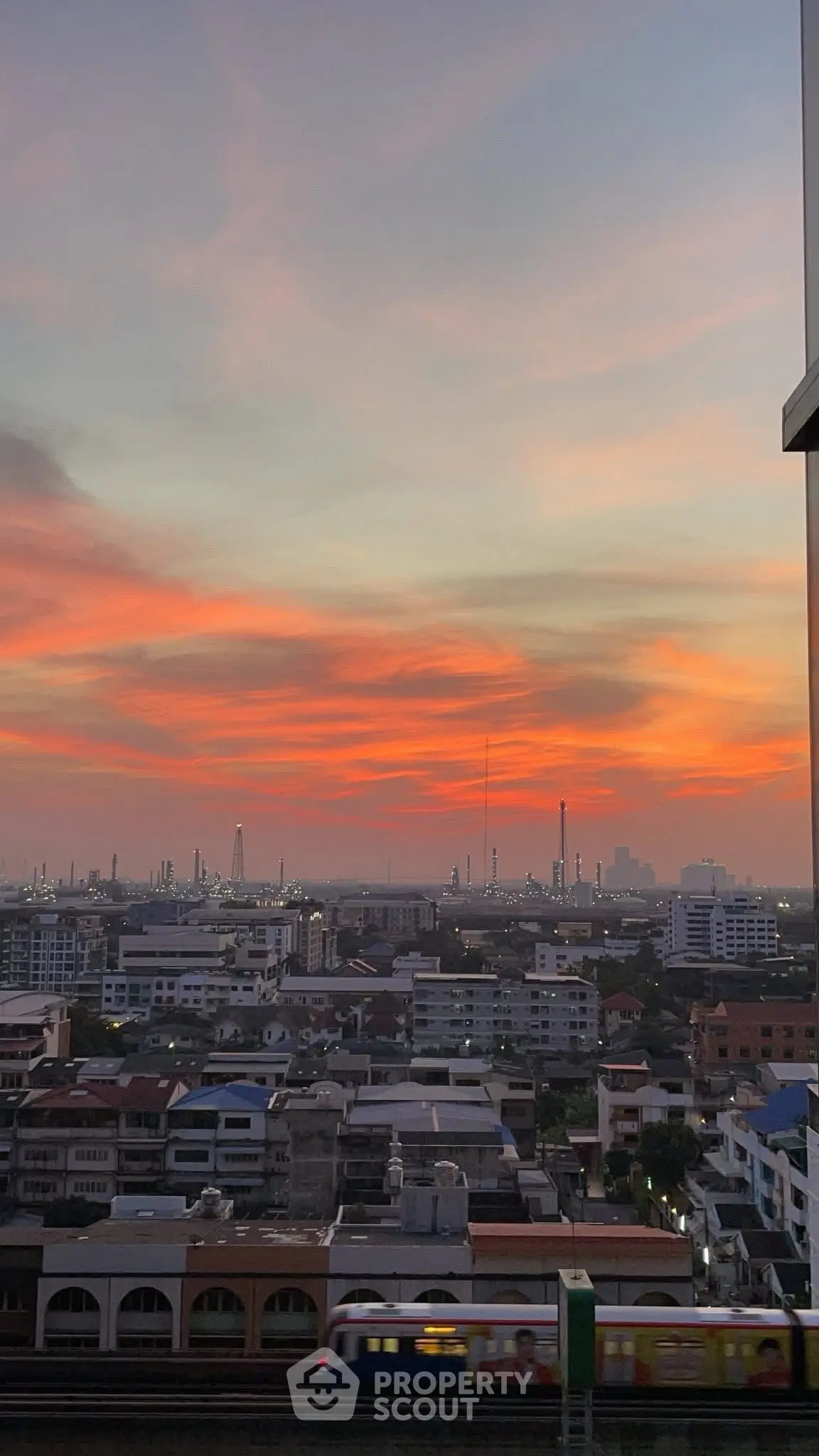 Stunning cityscape view at sunset with vibrant sky over urban skyline.