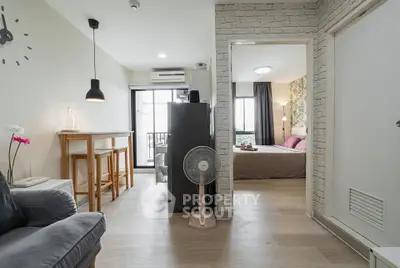 Modern apartment interior with open layout, featuring a cozy living area and stylish bedroom.