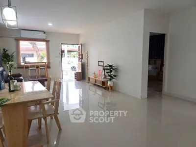 Spacious open-plan living and dining area with modern decor and natural light.