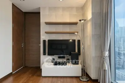 Modern living room with sleek TV setup and city view window