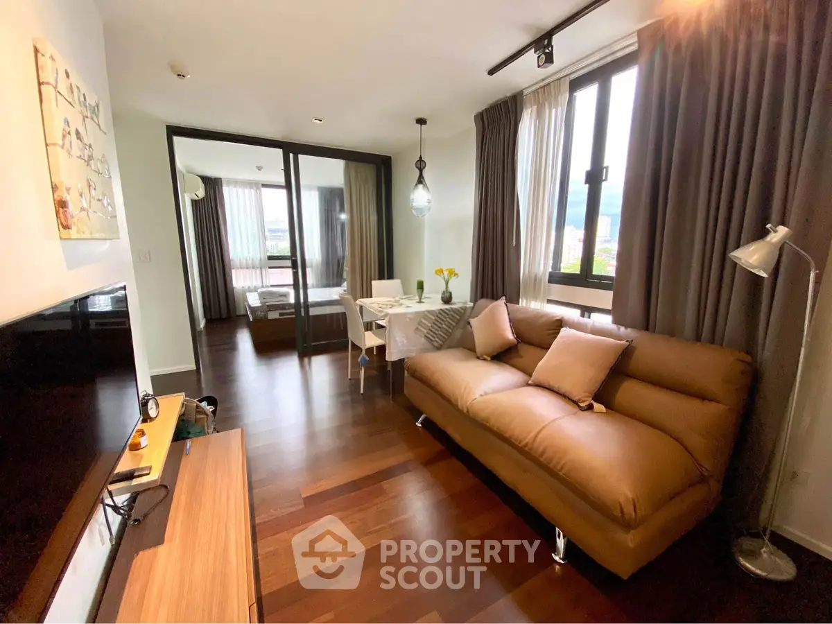 Modern living room with stylish decor and natural light in a contemporary apartment.