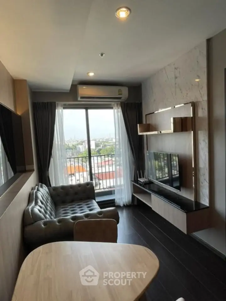Modern living room with city view, featuring stylish furniture and elegant decor.