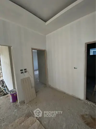 Unfinished interior space with drywall and construction materials