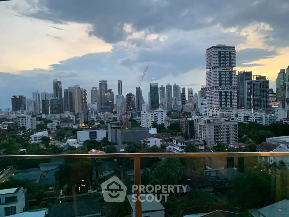 Stunning city skyline view from a high-rise balcony at dusk, showcasing modern skyscrapers and urban landscape.