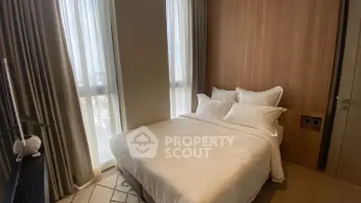 Cozy bedroom with natural light and elegant decor, perfect for relaxation.