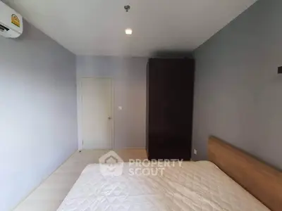 Spacious bedroom with minimalist design and ample natural light