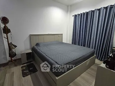 Modern bedroom with sleek design, featuring a comfortable bed and stylish curtains, perfect for relaxation.