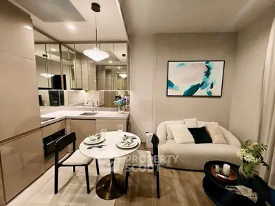 Modern open-layout kitchen and cozy living area with stylish decor and elegant dining setup.