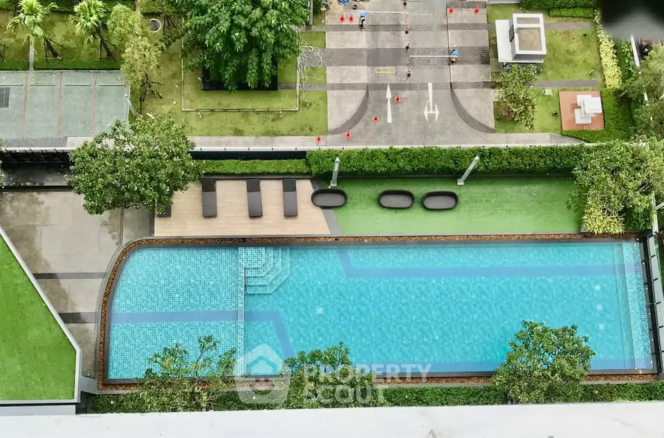 Stunning aerial view of a luxurious swimming pool in a modern residential complex.