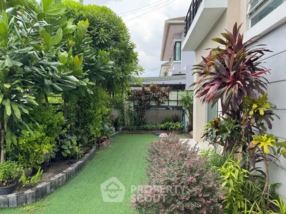 Lush garden view of a modern home with vibrant greenery and a well-maintained lawn.
