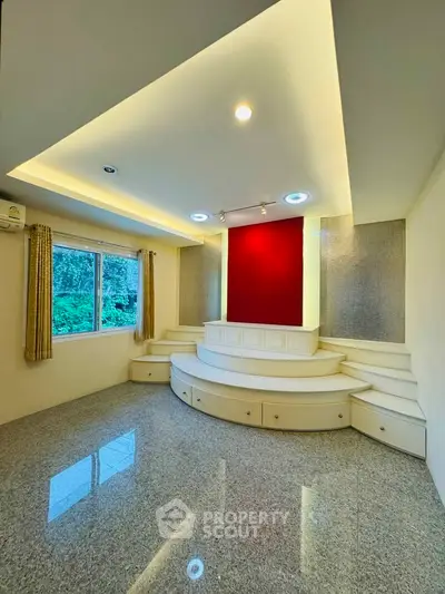 Elegant living room with unique elevated platform and modern lighting