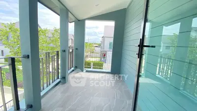 Spacious modern balcony with sleek design and scenic view in a contemporary home.