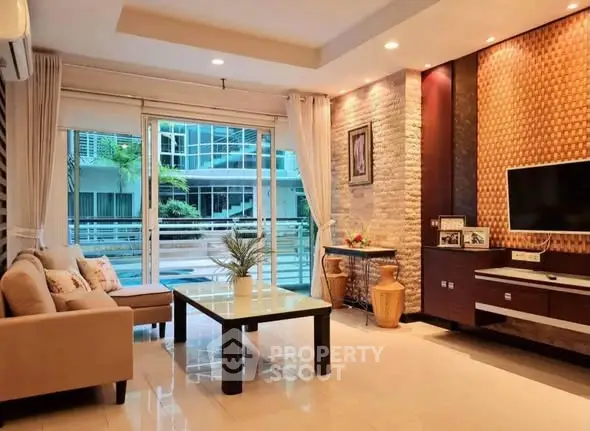 Spacious modern living room with elegant decor and large windows offering natural light.