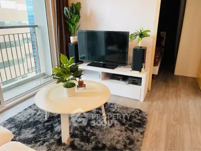 Modern living room with balcony, stylish decor, and entertainment setup.