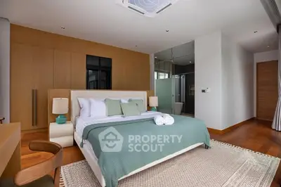 Luxurious bedroom with modern design and ensuite bathroom in a stylish apartment.