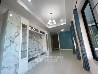 Elegant modern living room with marble accents and large windows