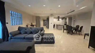 Spacious modern living room with open layout and elegant dining area, perfect for entertaining guests.