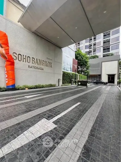 Modern entrance of Soho Bangkok Ratchada with sleek design and urban appeal.