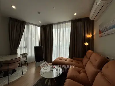 Modern living room with stylish furniture and large windows