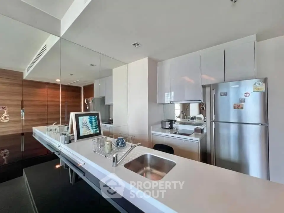 Modern kitchen with sleek design, featuring stainless steel appliances and a minimalist aesthetic.