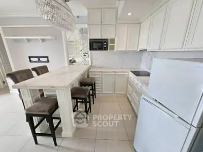 Elegant kitchen with marble countertops and modern appliances in a stylish open layout.