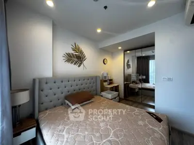 Modern bedroom with stylish decor and mirrored wardrobe in a cozy apartment.
