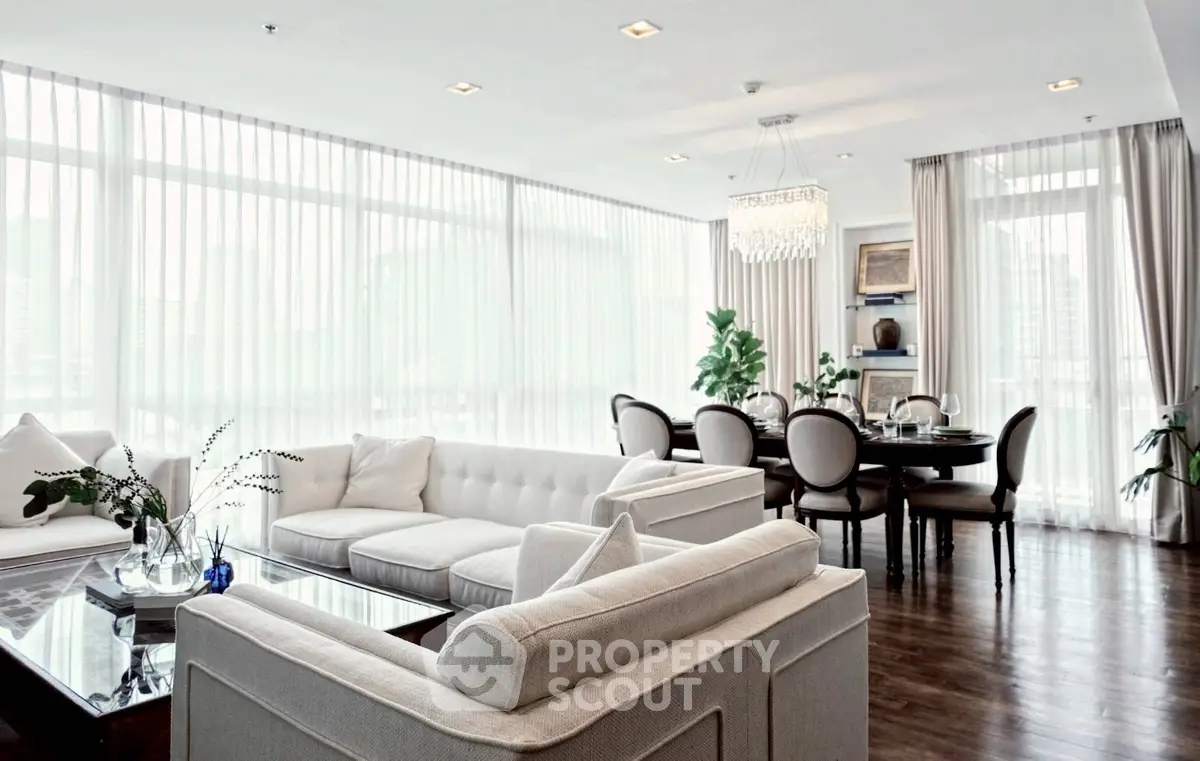 Luxurious living room with elegant dining area and floor-to-ceiling windows in modern apartment.