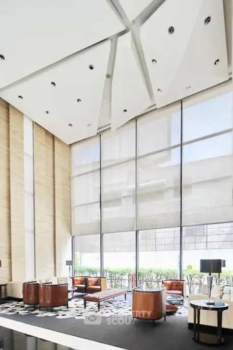 Luxurious modern lobby with high ceilings and elegant furnishings in a prestigious building.