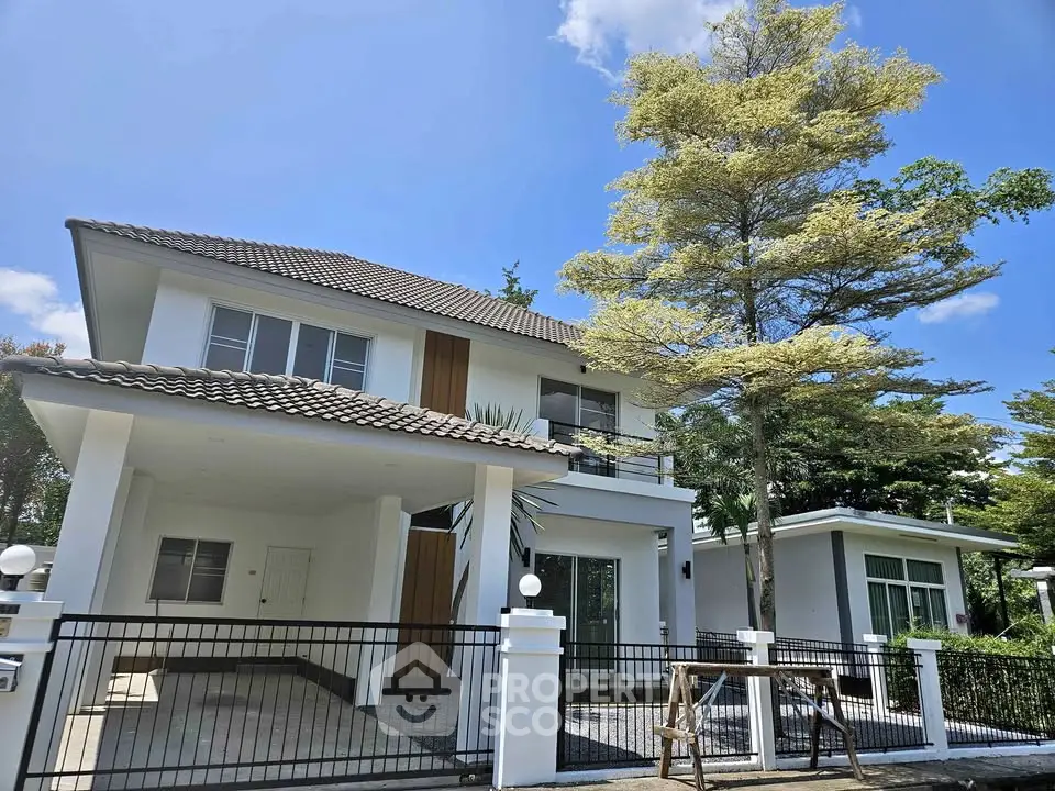 Stunning modern two-story house with spacious driveway and lush greenery, perfect for family living.