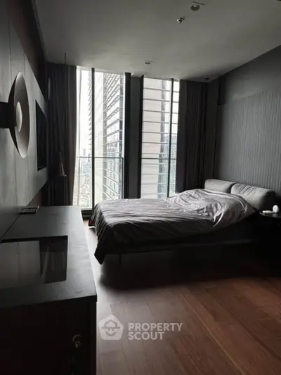 Modern bedroom with floor-to-ceiling windows and stylish decor