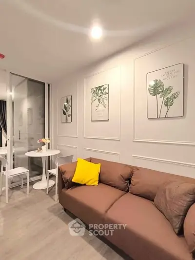 Chic modern living room with cozy brown sofa and stylish wall art in a contemporary apartment.