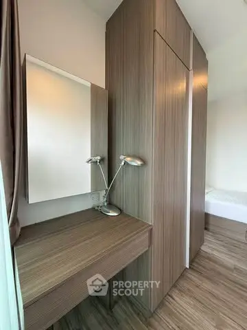Modern bedroom with sleek wooden furniture and stylish desk lamp