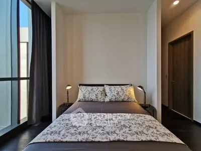 Modern bedroom with floor-to-ceiling windows and stylish decor