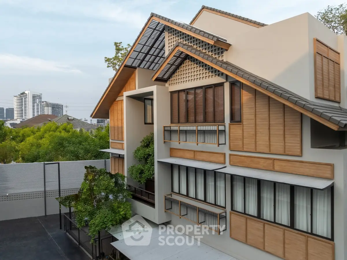 Modern architectural home with wooden accents and lush greenery, offering a serene urban retreat.