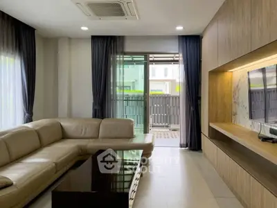 Modern living room with sleek design and large windows for natural light.