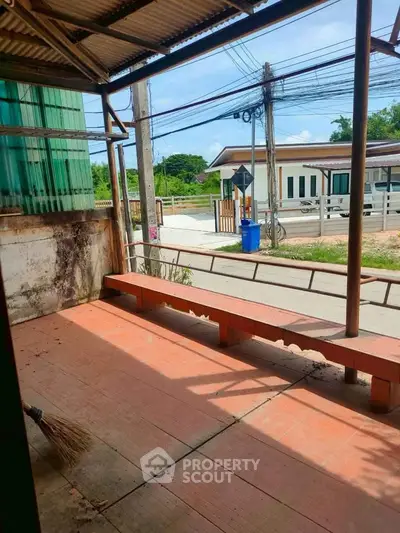Charming rustic porch with street view, perfect for relaxing outdoors.