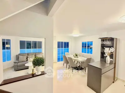 Spacious modern living and dining area with elegant decor and large windows.