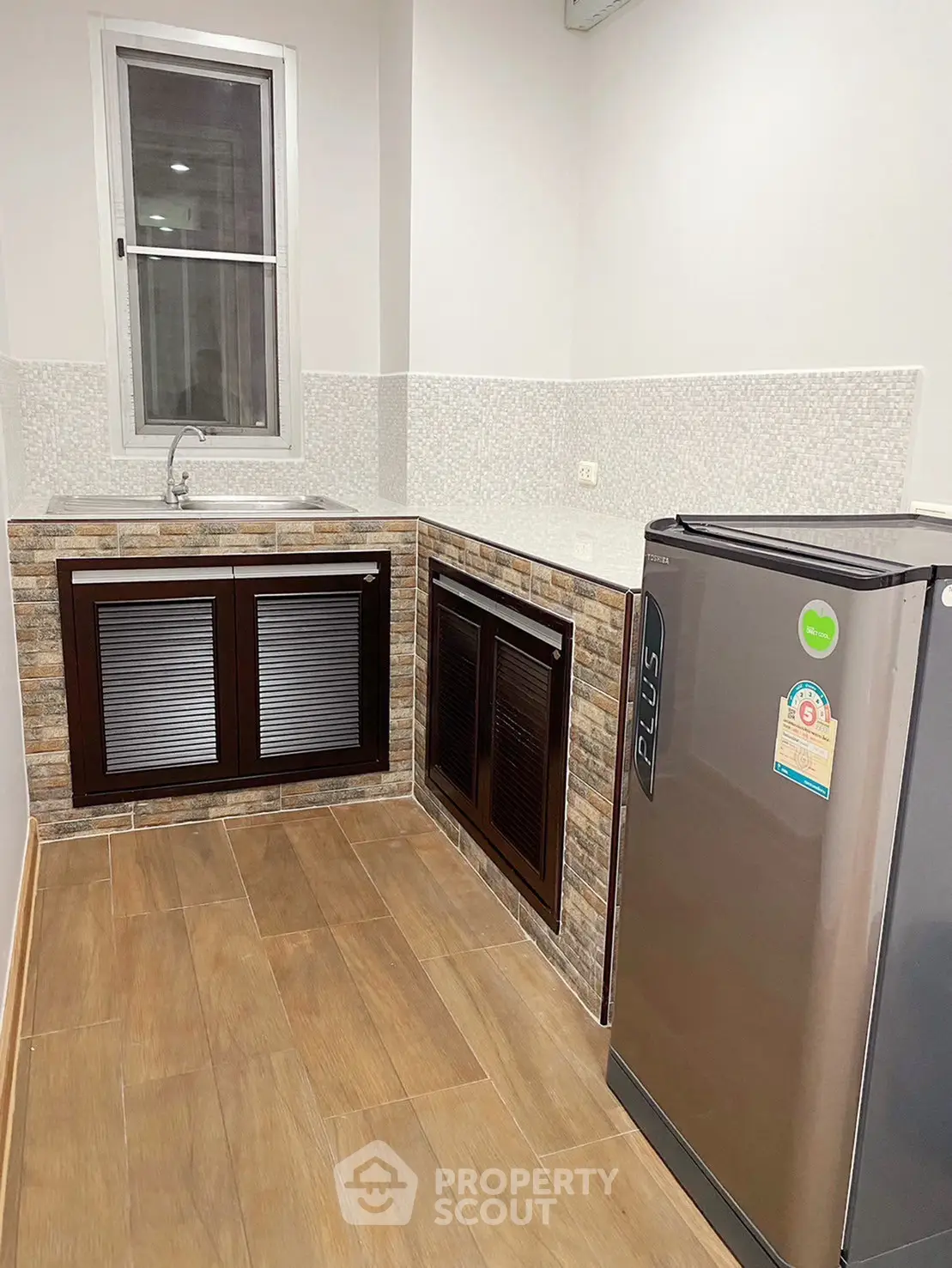 Modern kitchen with sleek appliances and stylish cabinetry in a contemporary home.