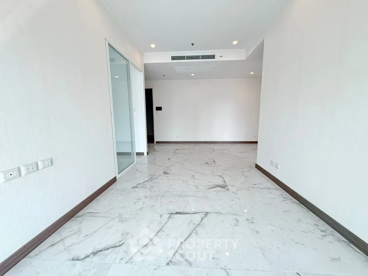 Spacious modern living room with marble flooring and recessed lighting